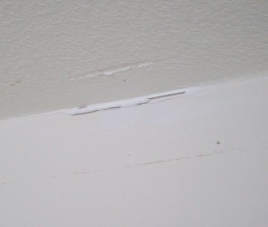 Cracks in the drywall between the wall and the ceiling